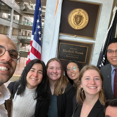 Students pose in front of Elizabeth Warren's senate office