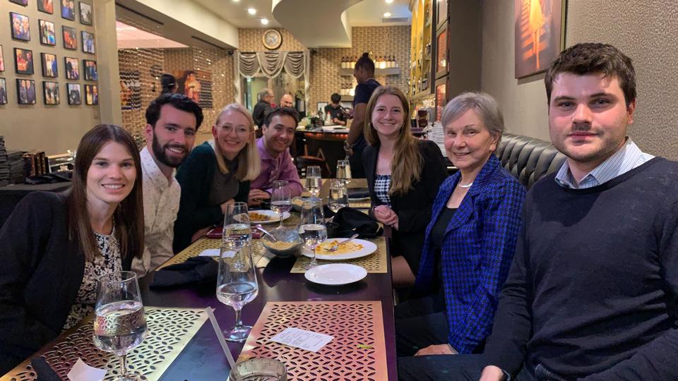 Students at dinner smile for the picture