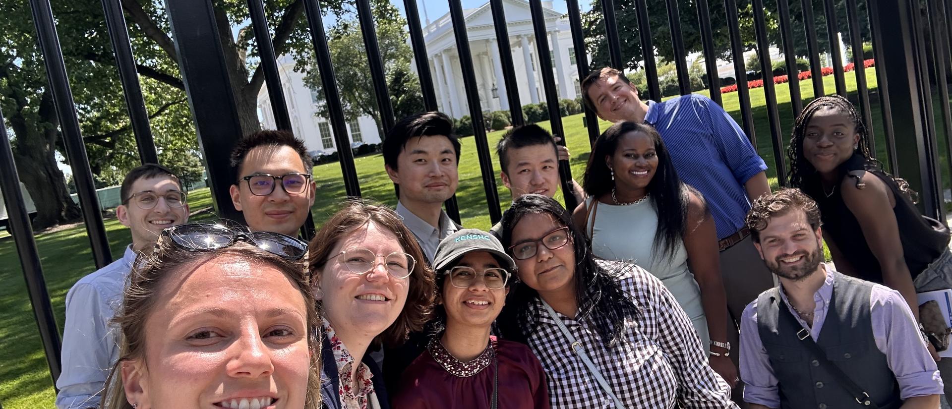 A group of students pose for a selfie in front of the White House
