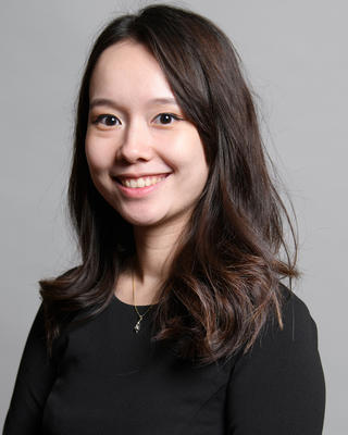 Jessica Smiles for the camera wearing a dark top