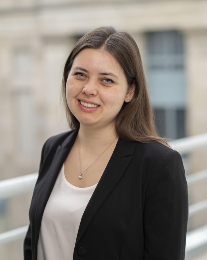 Antonia smiles for the camera wearing a blazer and a white top