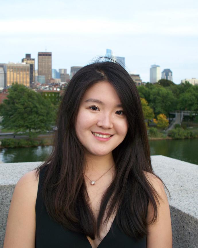 Joanne smiles in front of a cityscape